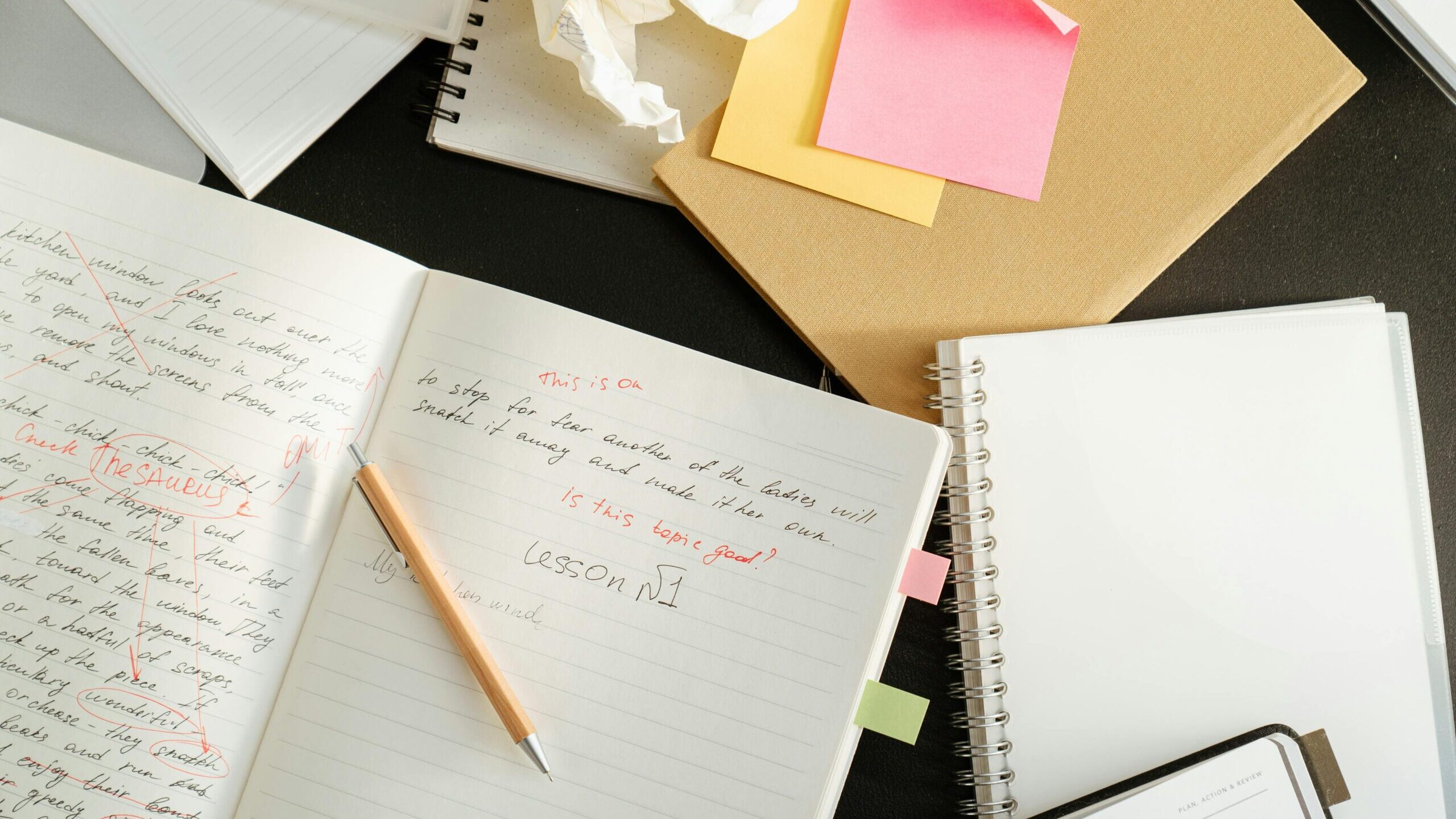 A digital product creator's messy desk with scribbled notes during the product creation process.